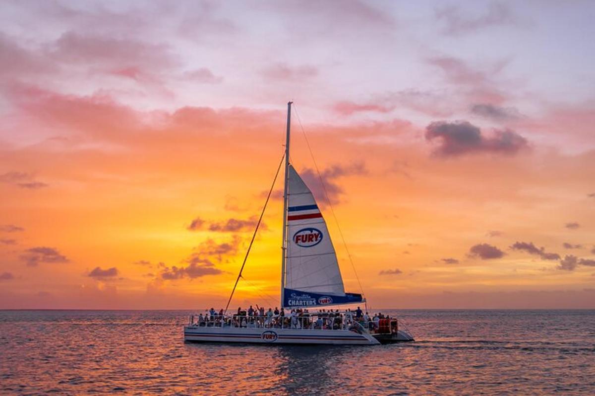 a group of people on a sail boat in the ocean