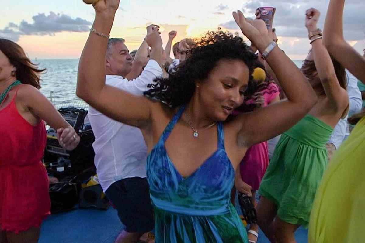 a group of people dancing on a boat