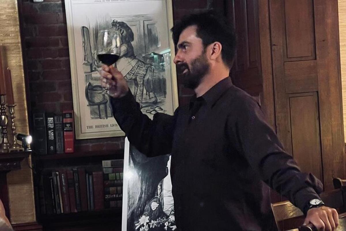 a man holding up a glass of wine