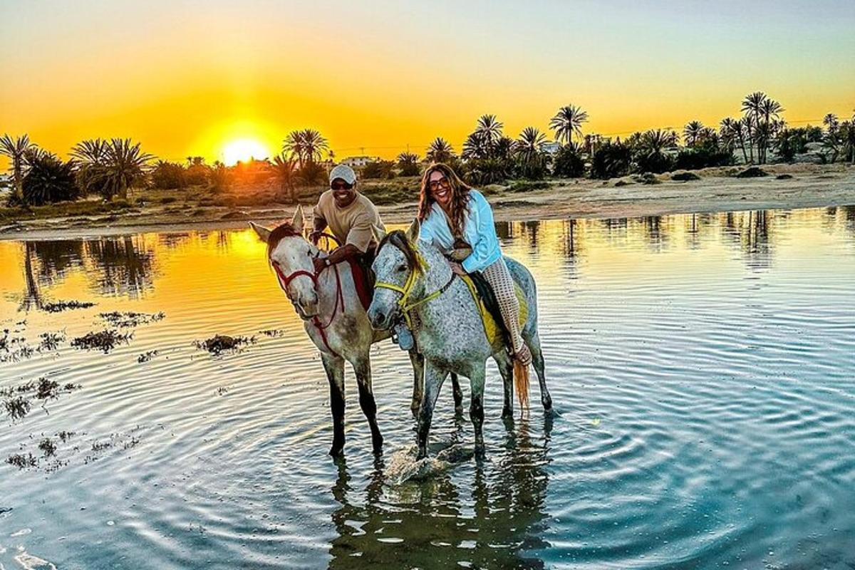 a man and woman riding horses in the water