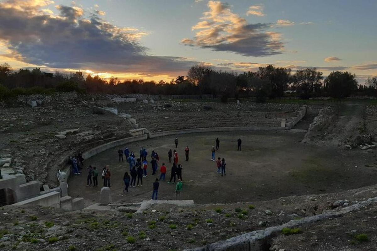 a group of people walking around an amphitheater