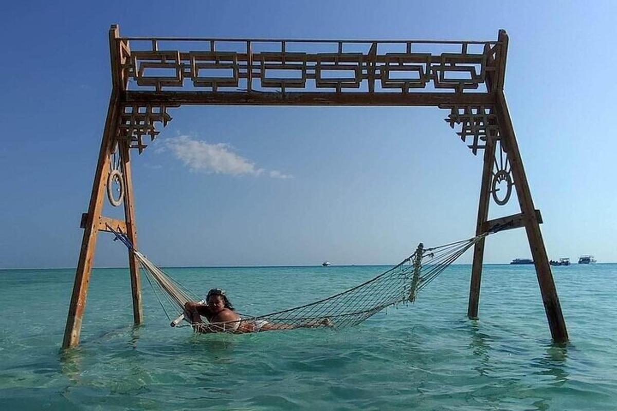 a woman laying in a hammock in the ocean