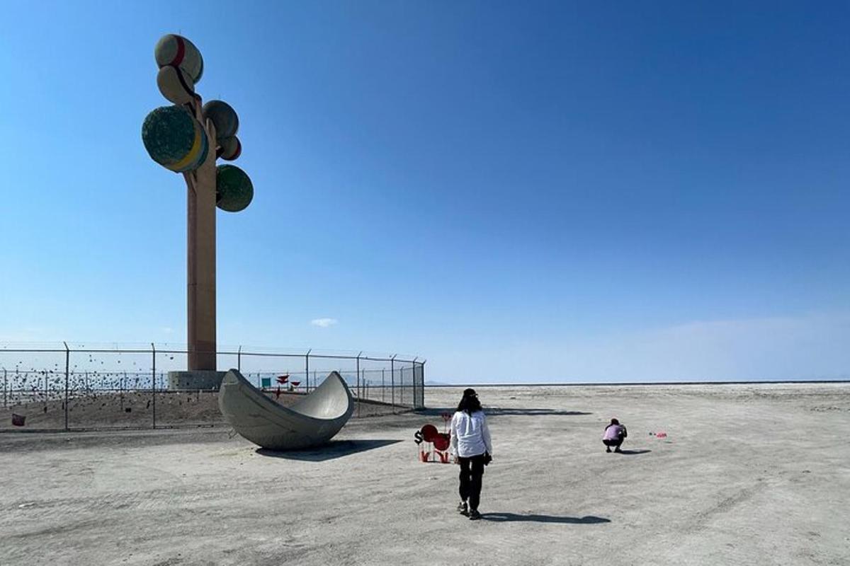 a woman walking on the beach near a boat