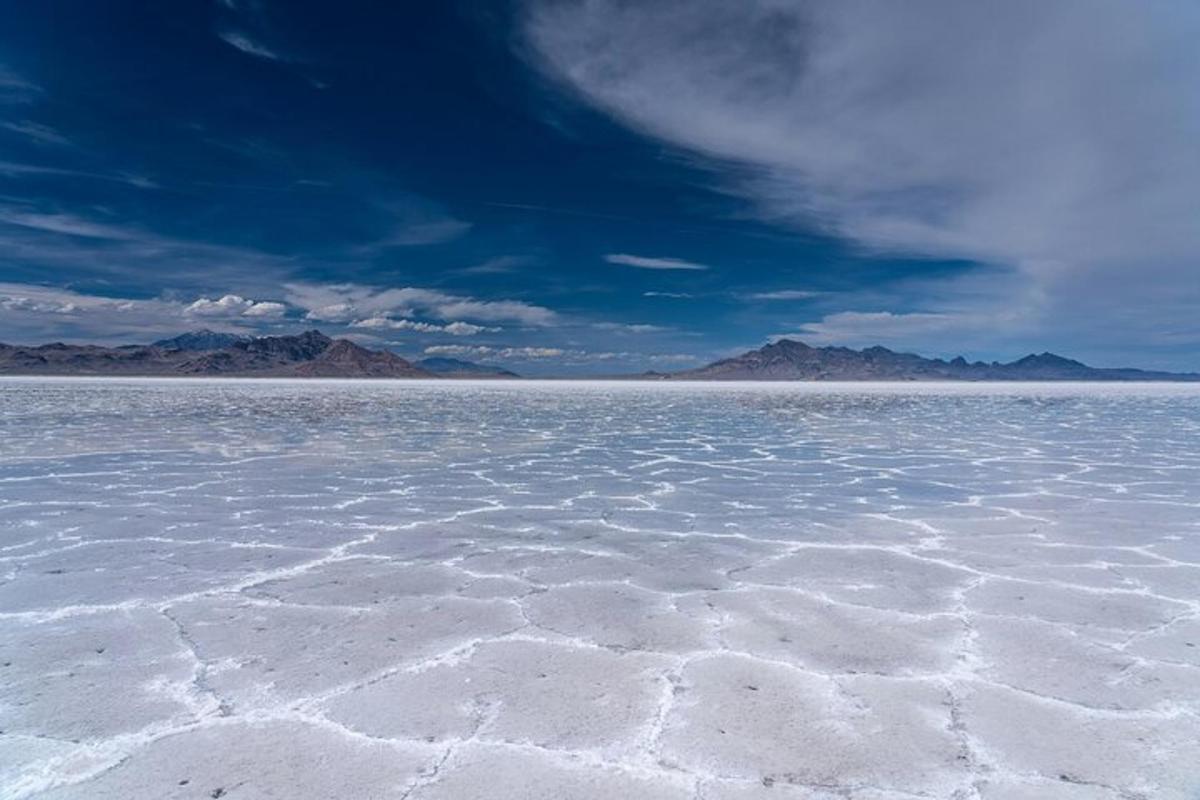 a large salt lake with mountains in the background