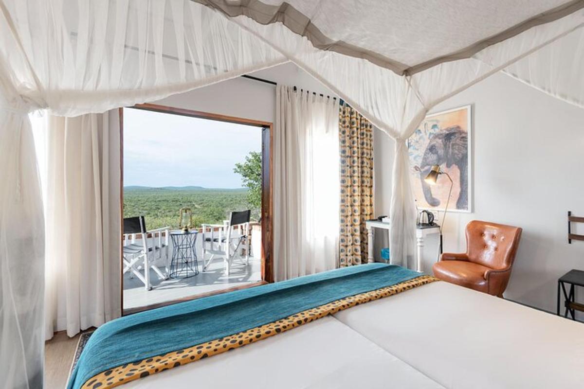 a bedroom with a bed and a view of a patio