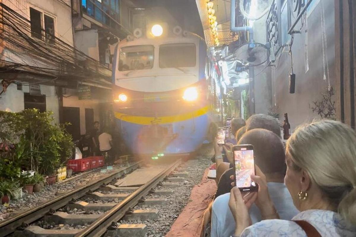 a crowd of people taking pictures of a train