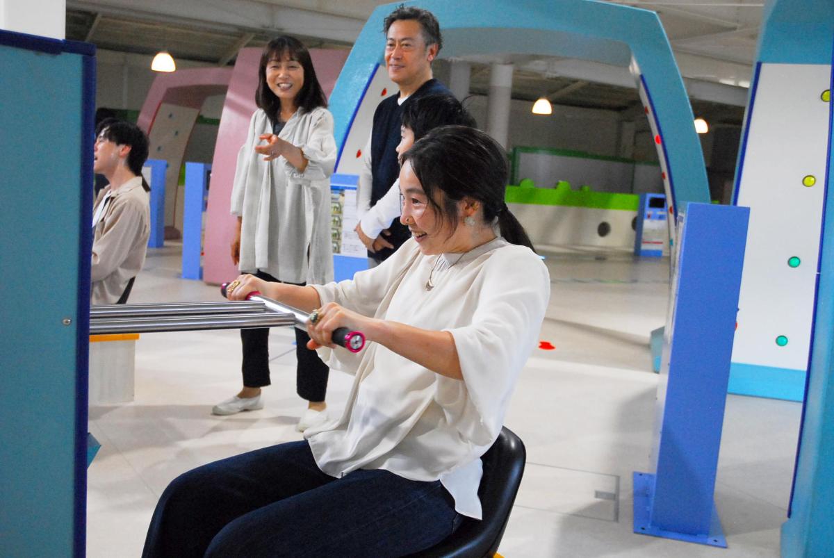a woman sitting in a chair playing a video game