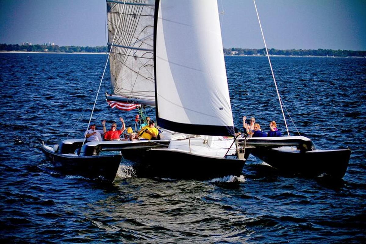 a group of people on a sail boat in the water