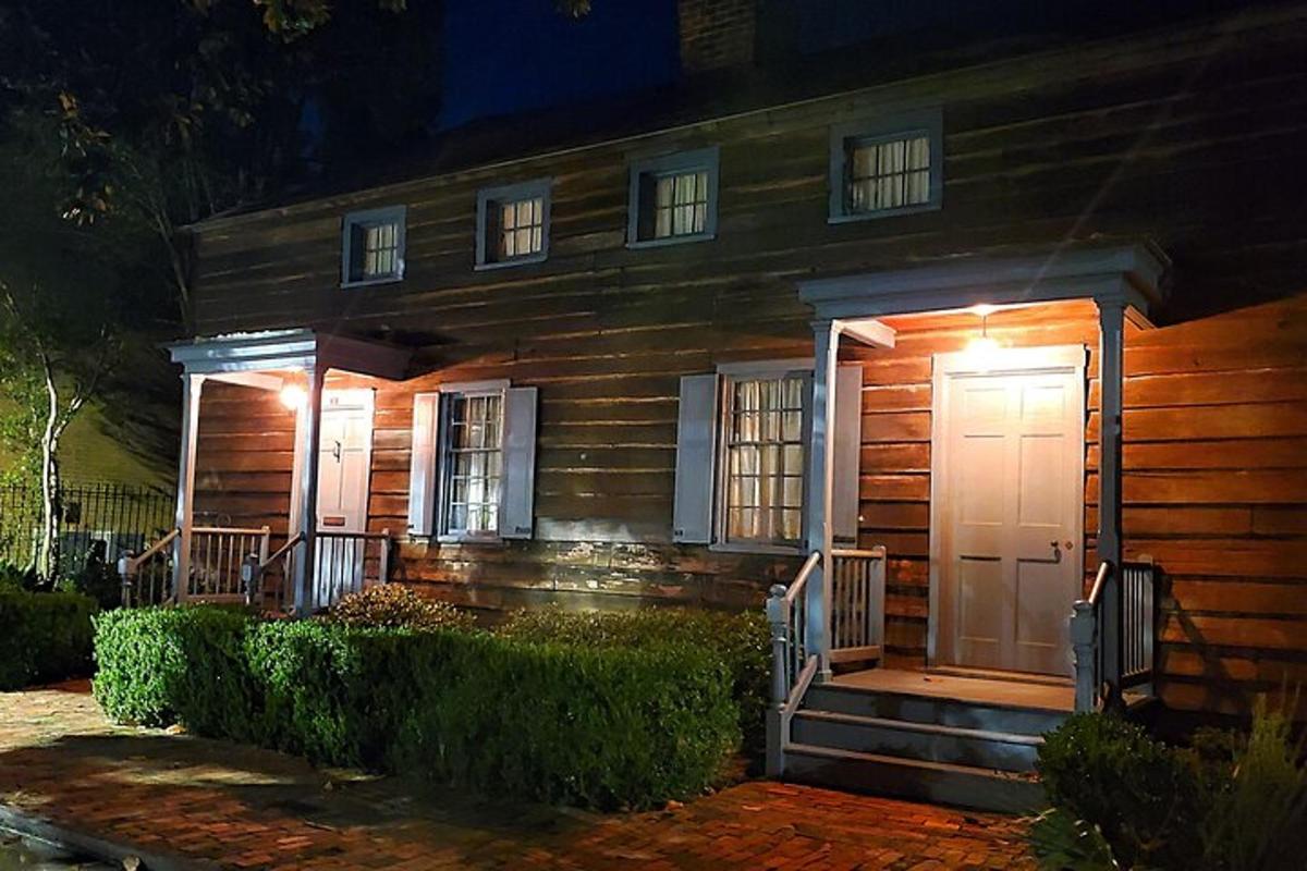 a wooden house with a porch and a white door