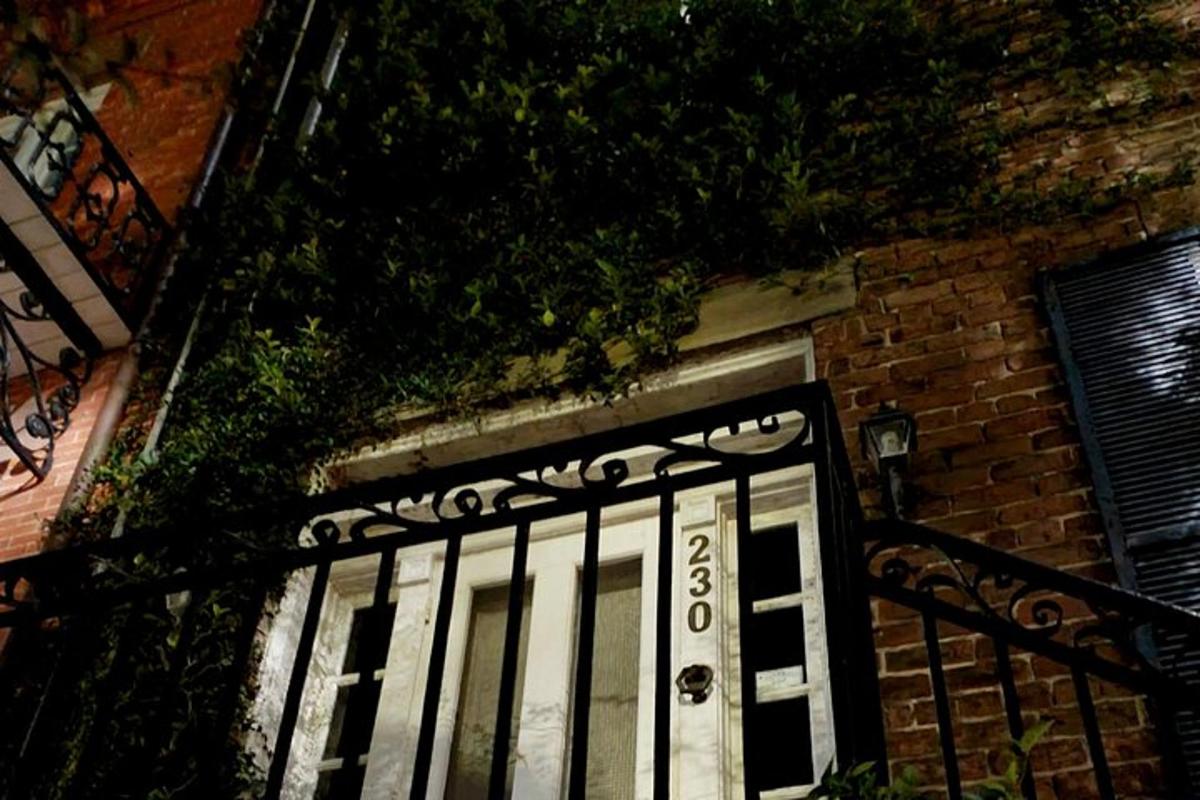 a black and white door on a brick building