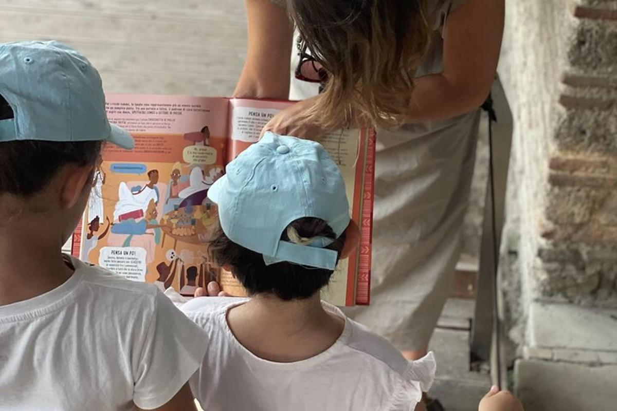 a young child wearing a hat looking at a magazine
