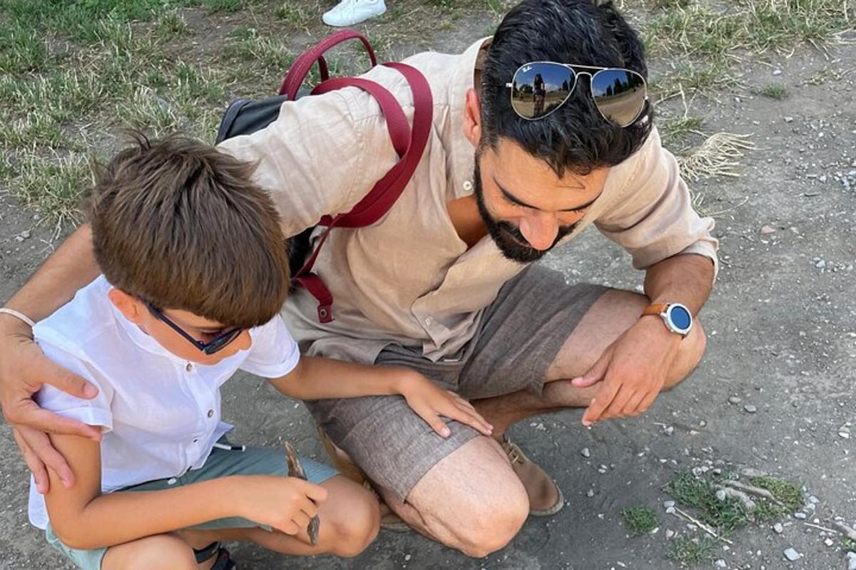 a man and a boy sitting on the ground