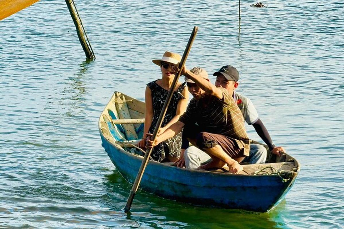 a group of people in a blue boat on the water
