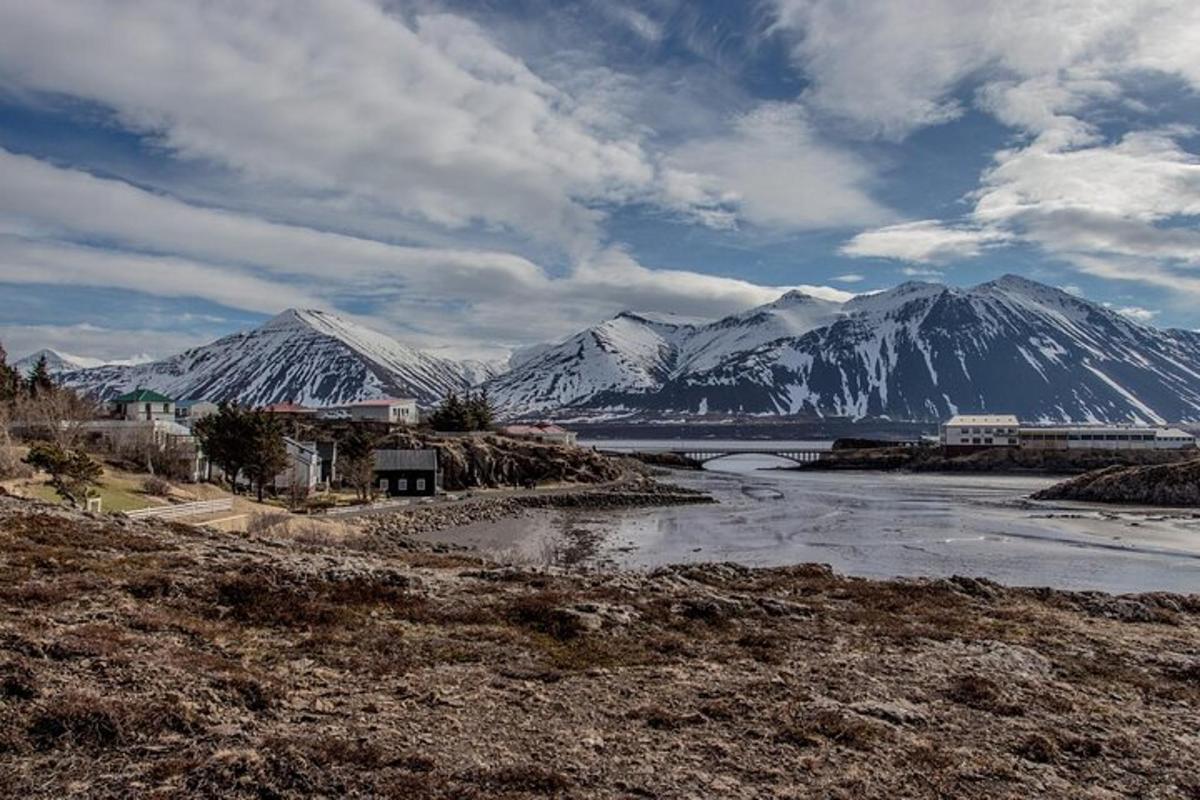 a river with snow covered mountains in the background