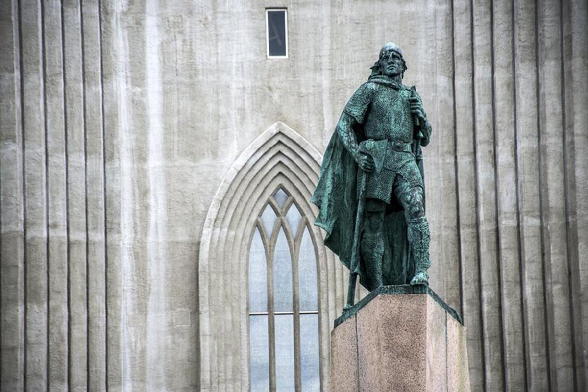 a statue of a man standing in front of a building