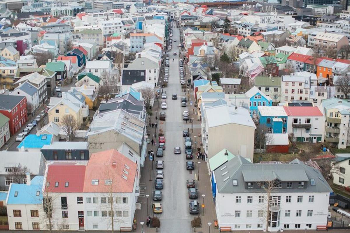 an aerial view of a city with cars driving down a street