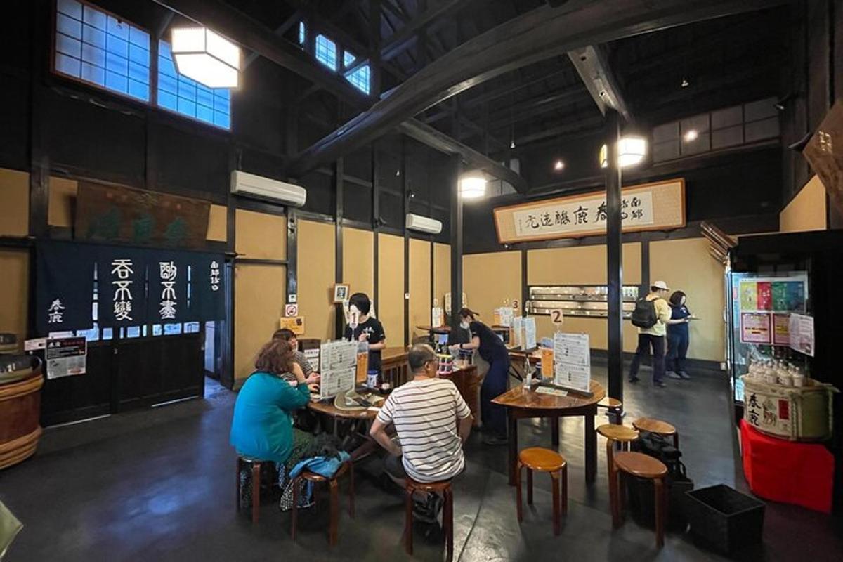 a group of people sitting at tables in a restaurant