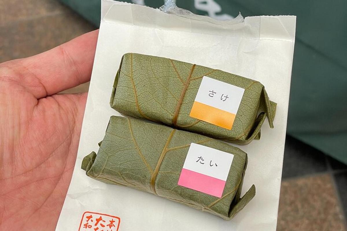 a hand holding two green wallets with price tags on them