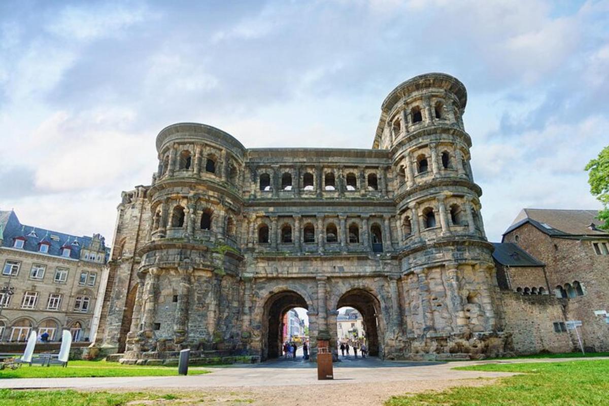 a large stone building with an arch in front of it