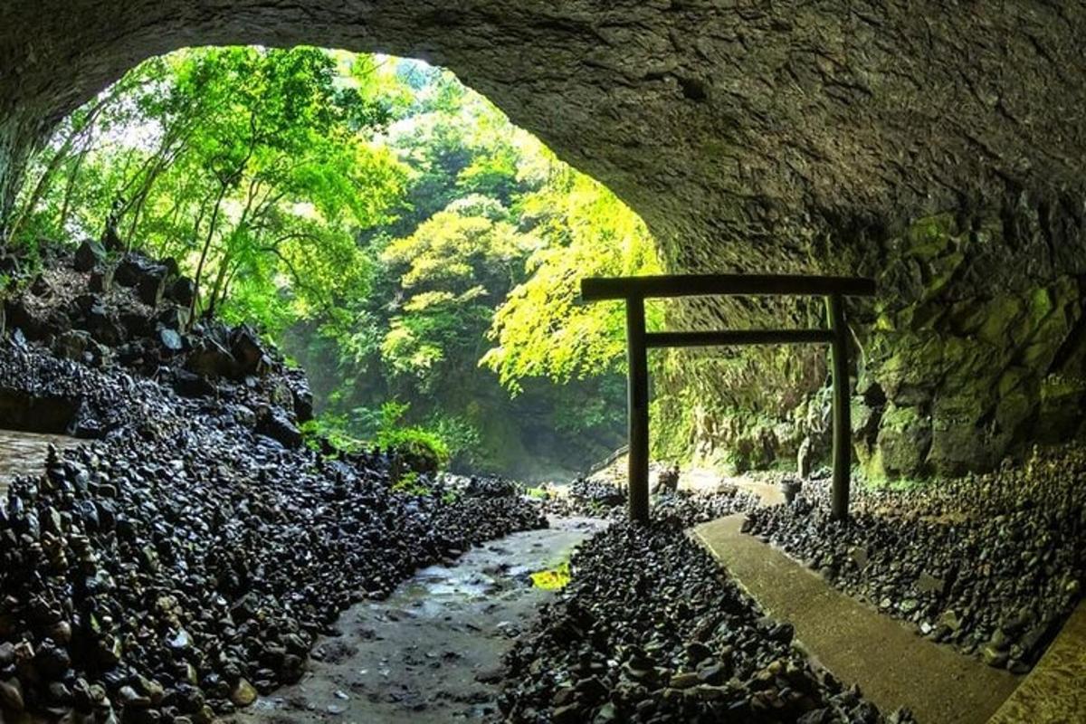 a stone tunnel with a sign in the middle