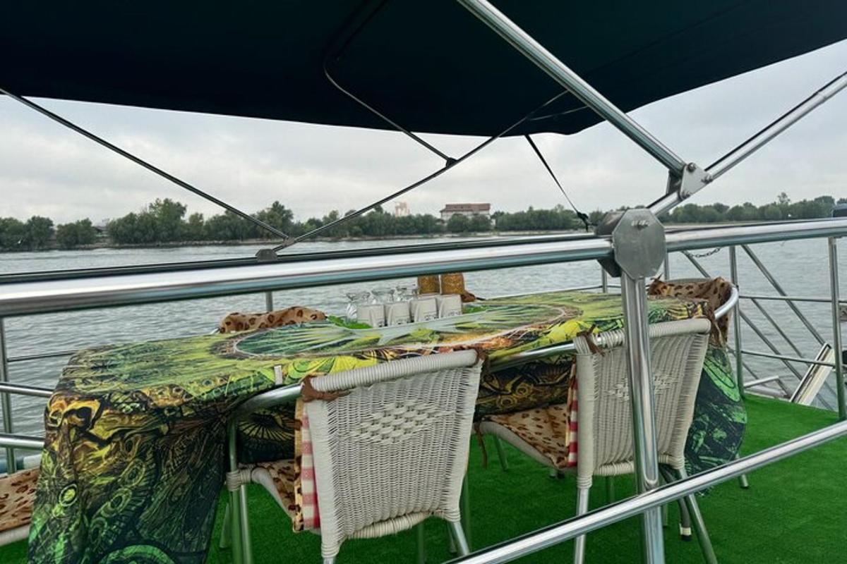 a table and chairs on a boat on the water