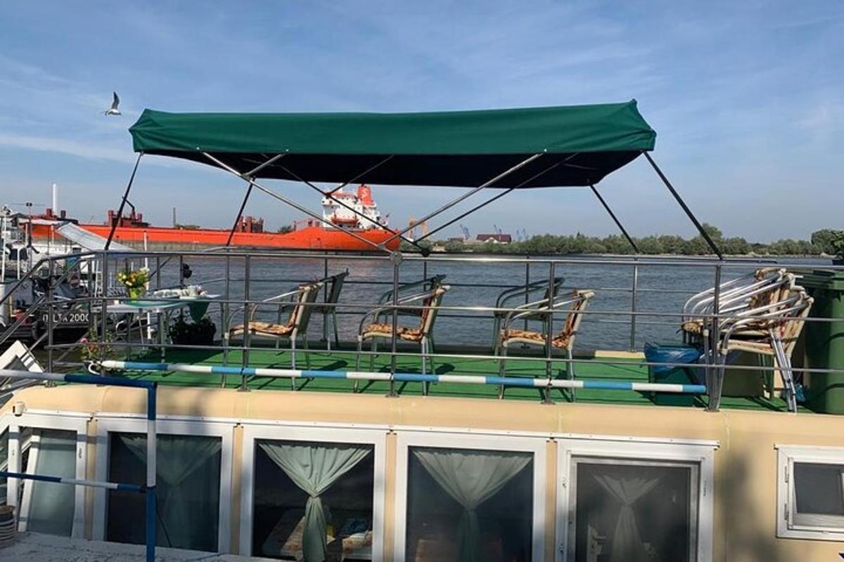 a boat with chairs and a canopy on the water