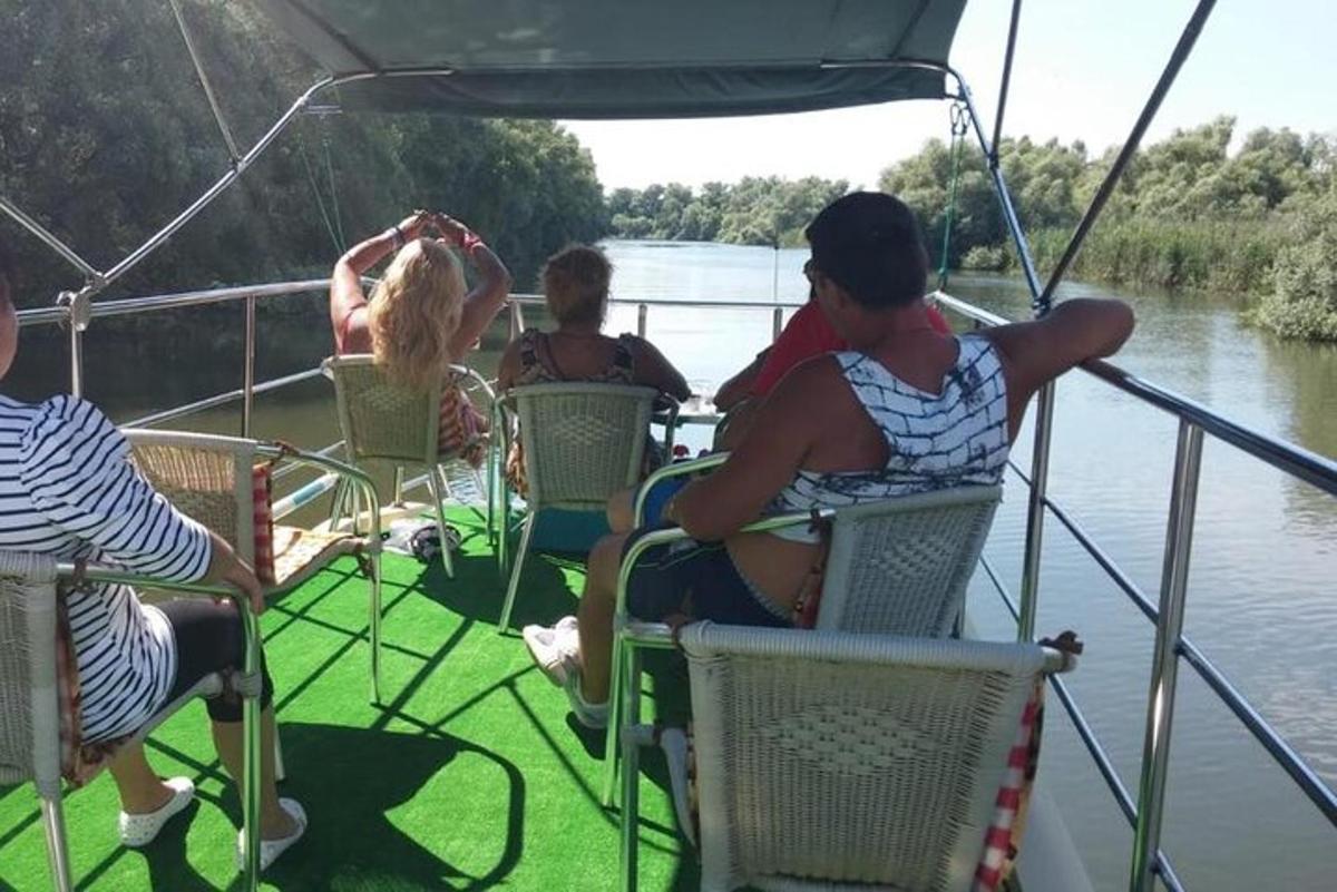 a group of people sitting on a boat on the water