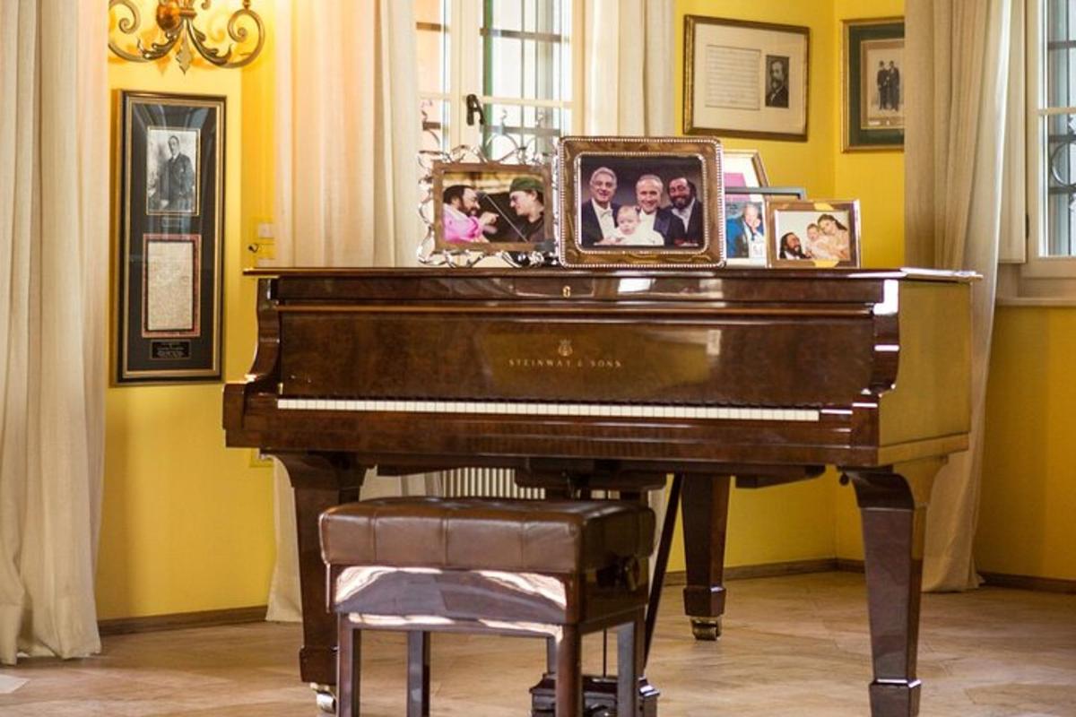 a piano in a room with pictures of people