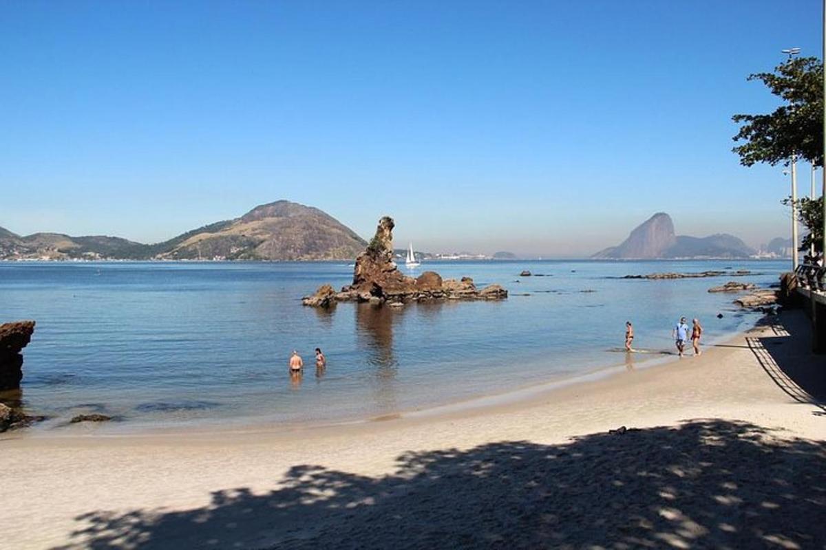 a group of people standing in the water on a beach