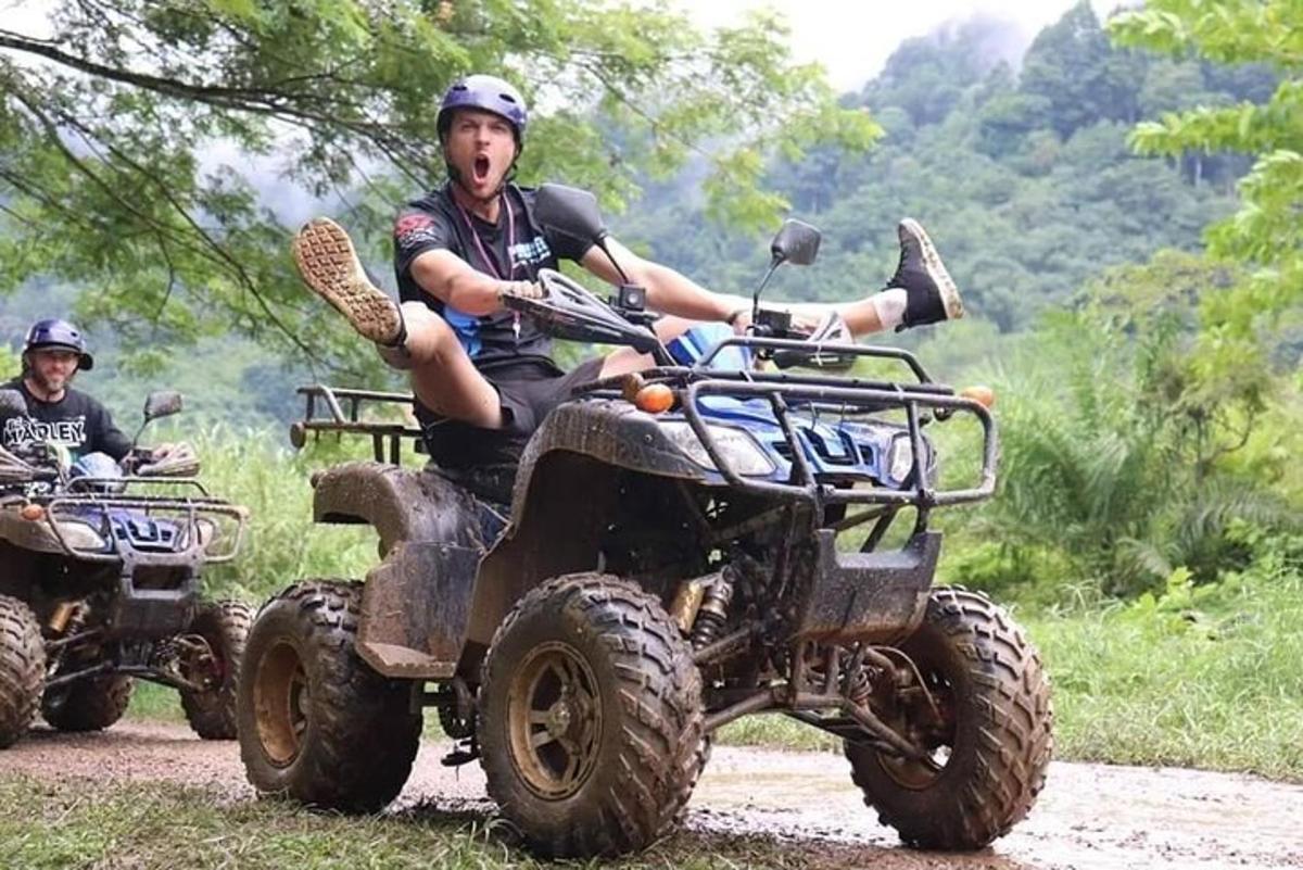 divi vīrieši brauc ar kvadracikliem pa zemes ceļu