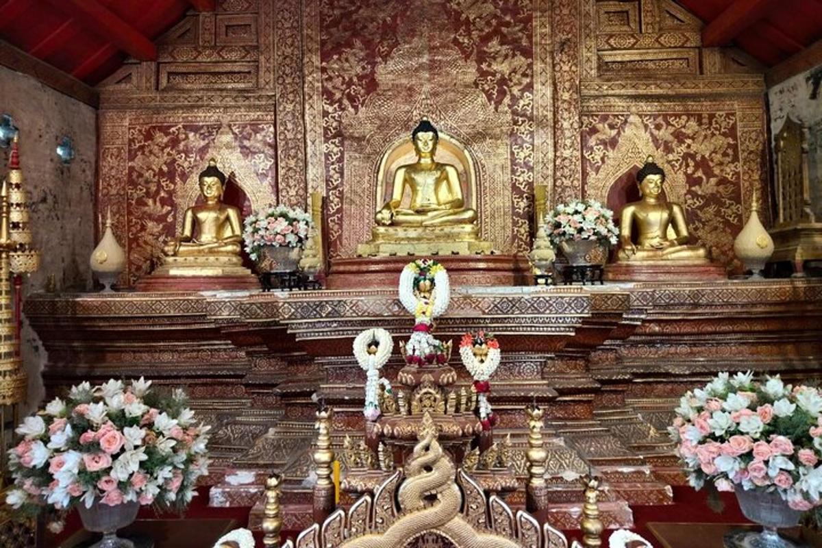 a temple with gold buddha statues on a wall
