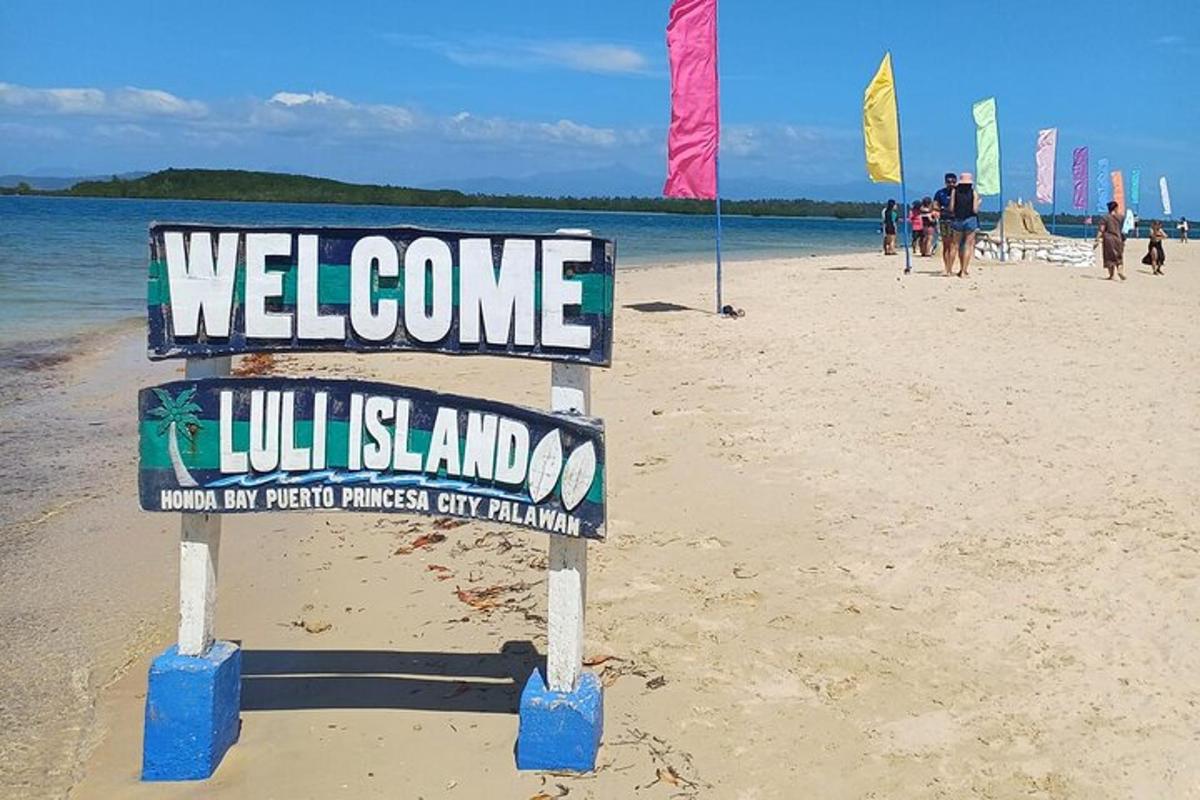 a welcome sign on a beach with people on the beach