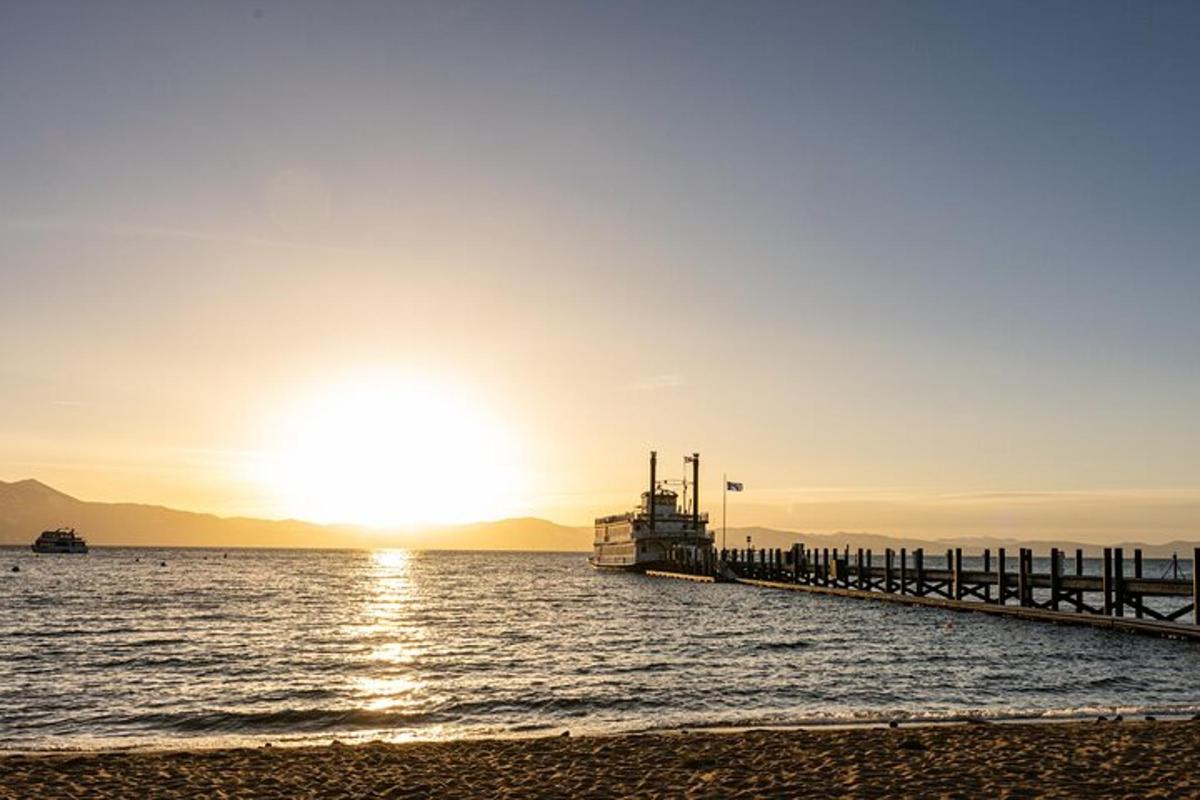 a pier with the sun setting over the water