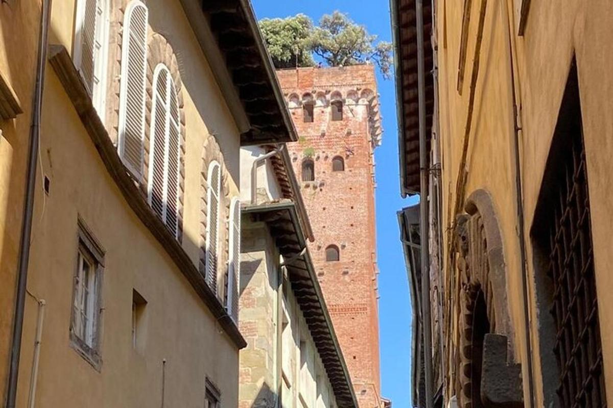 a tall brick building with a tower in the distance