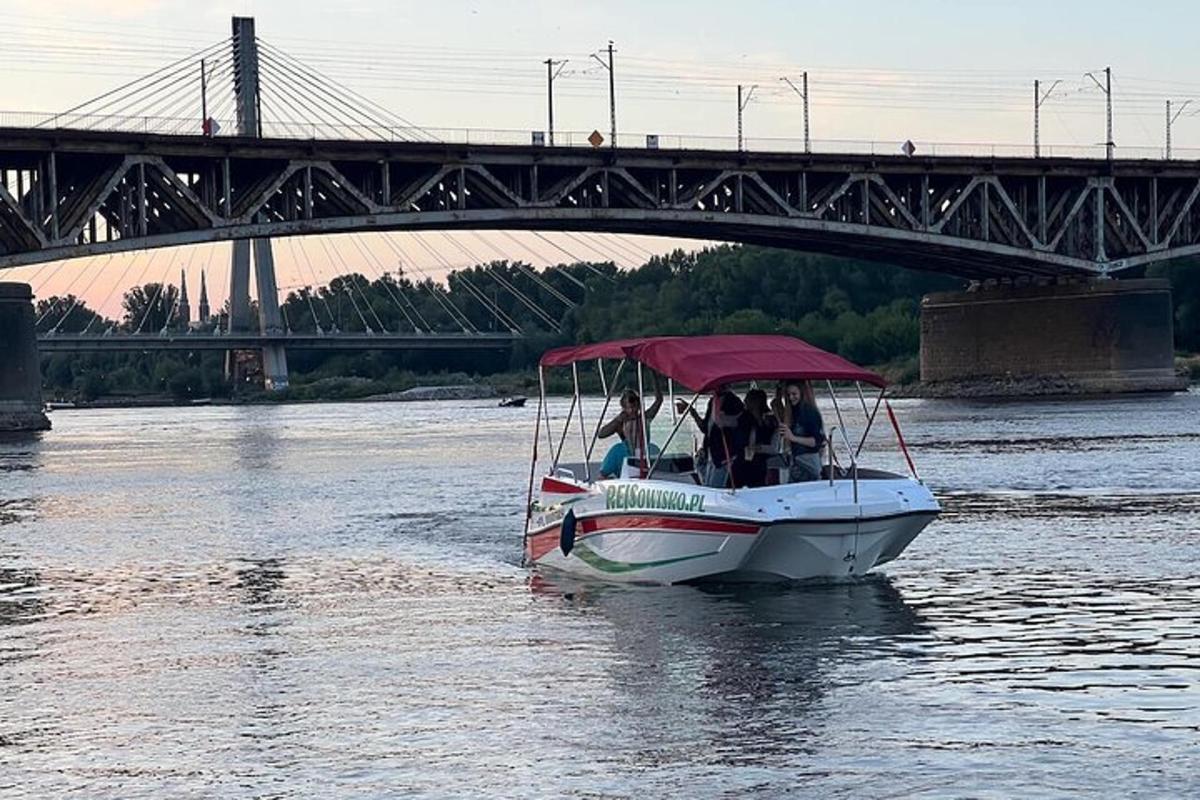 a boat on the water under a bridge