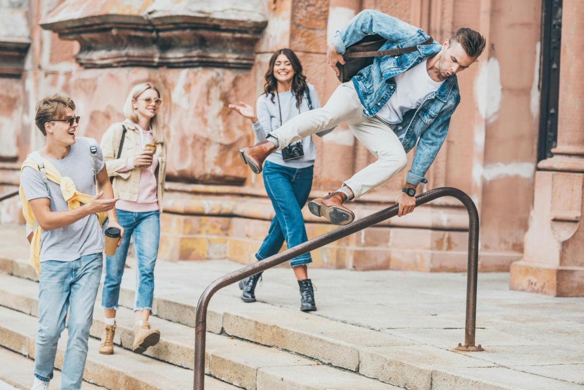 a man doing a trick on a skateboard on a rail