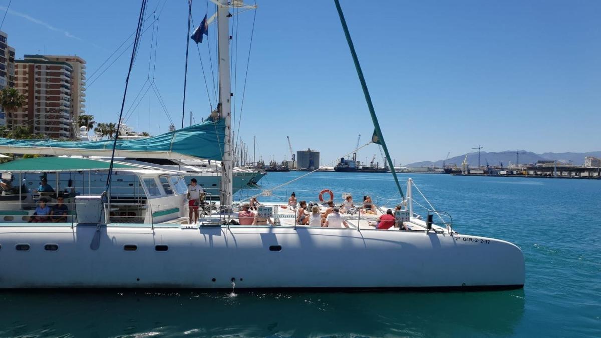 a group of people on a sailboat in the water