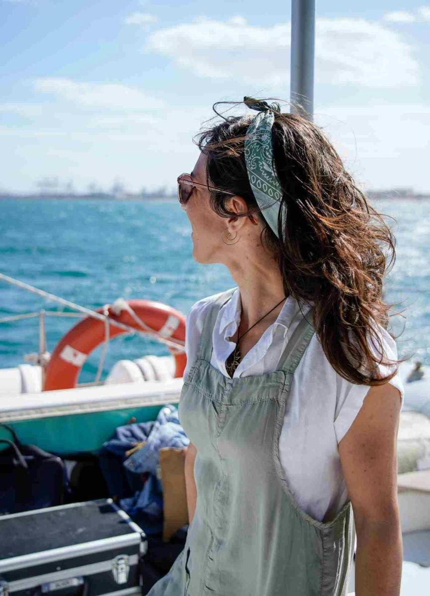 a woman standing on a boat in the water