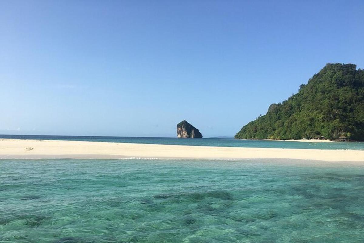 a beach with an island in the water