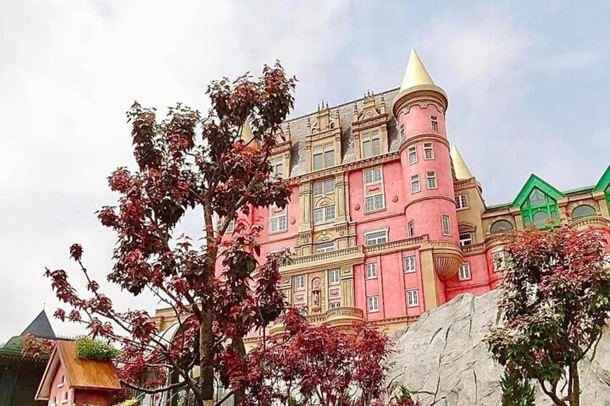 a large pink building with a tower on top of it