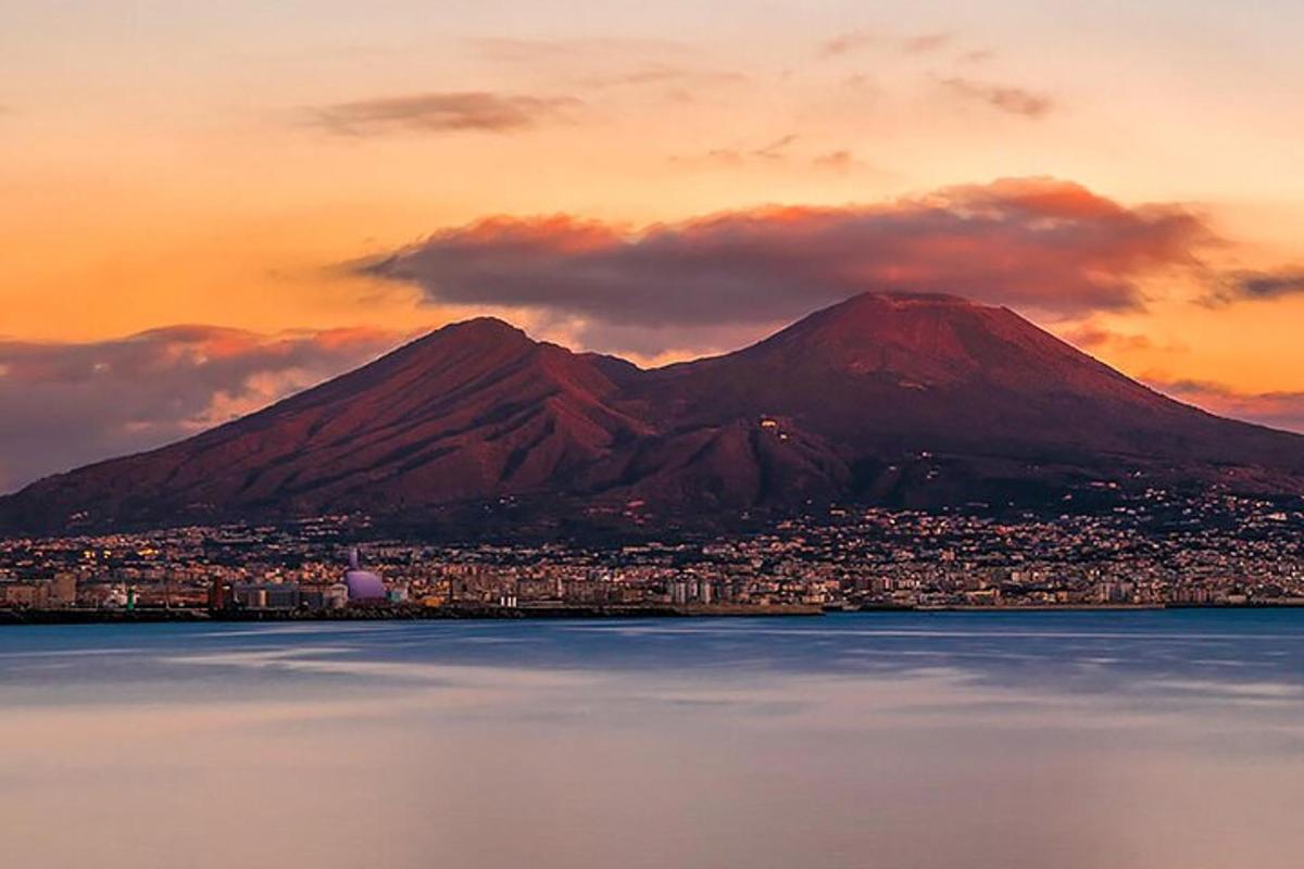a mountain with a city in front of the water
