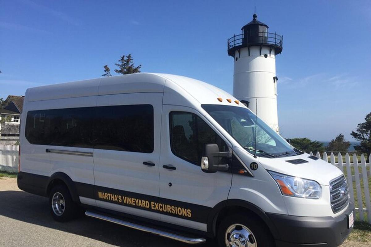 a white van parked in front of a lighthouse
