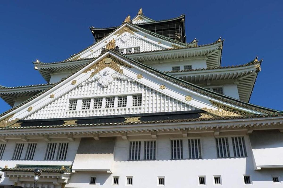 a tall white building with a black and white roof