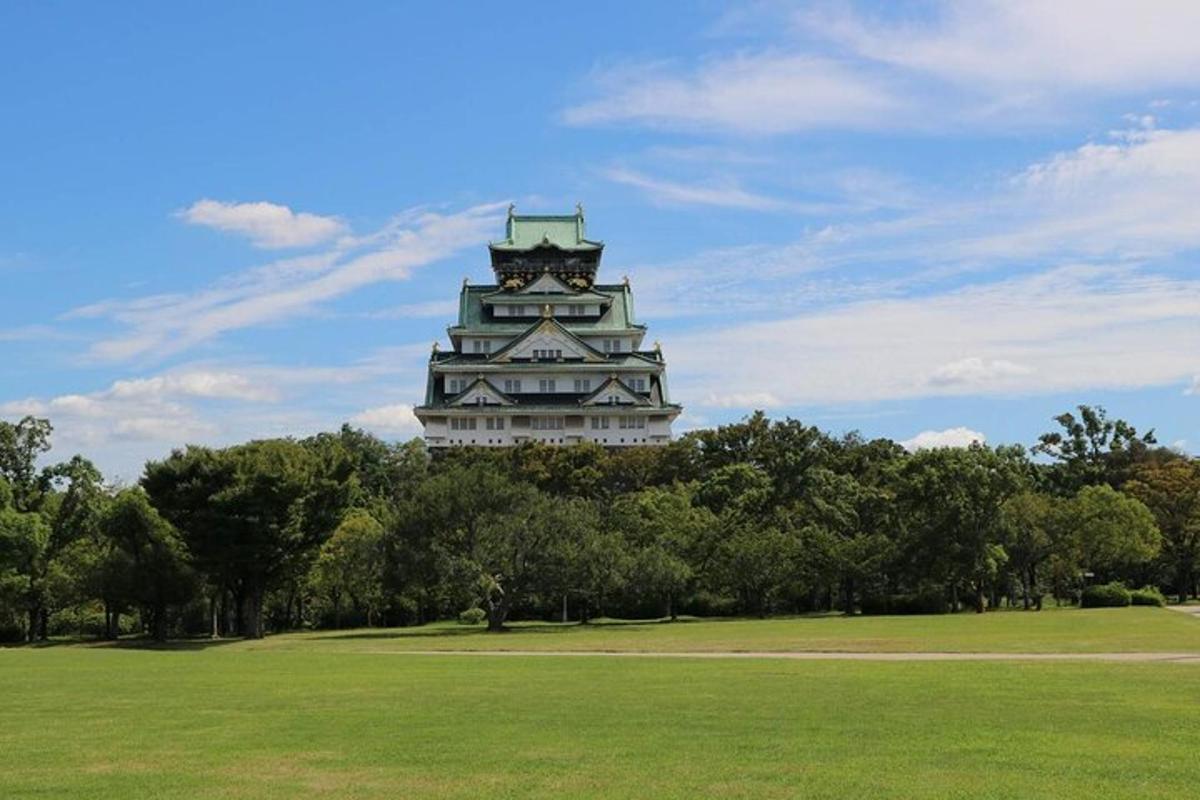 a large building with a clock tower in a park