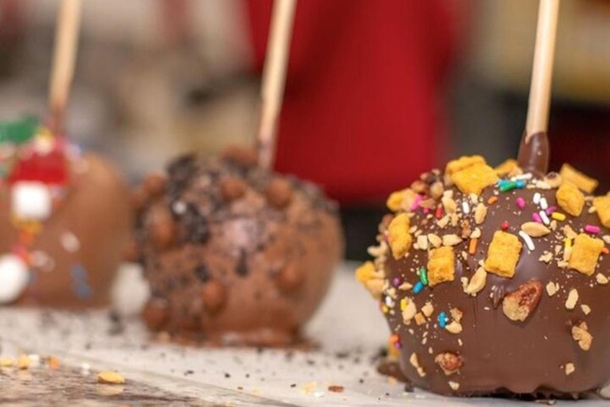 a group of chocolate covered donuts with sprinkles