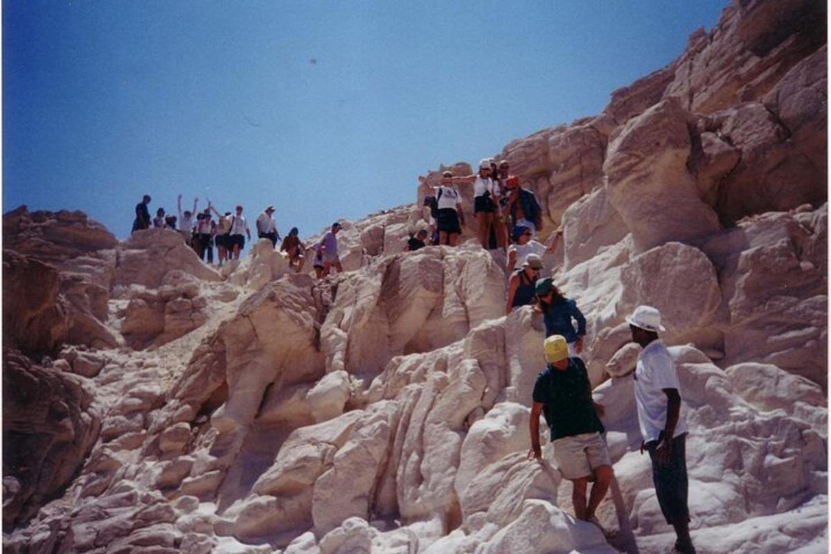 un gruppo di persone che camminano su una montagna rocciosa