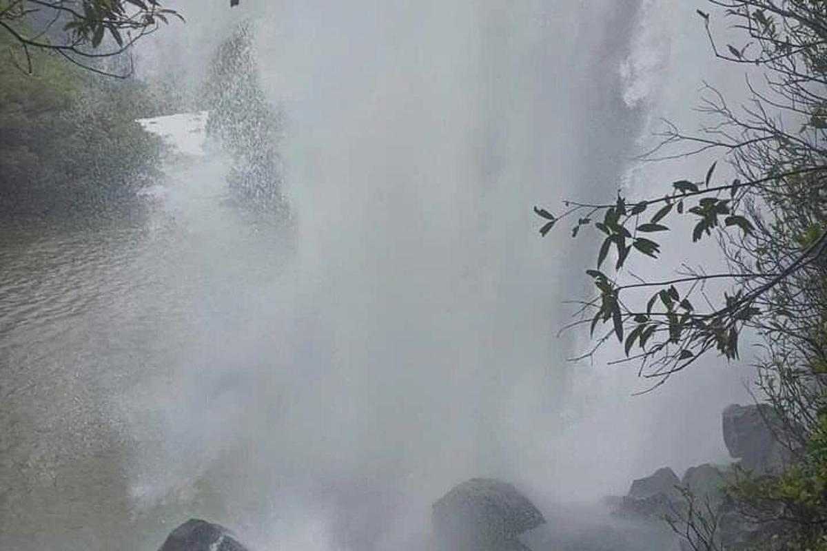 a waterfall in the middle of a body of water