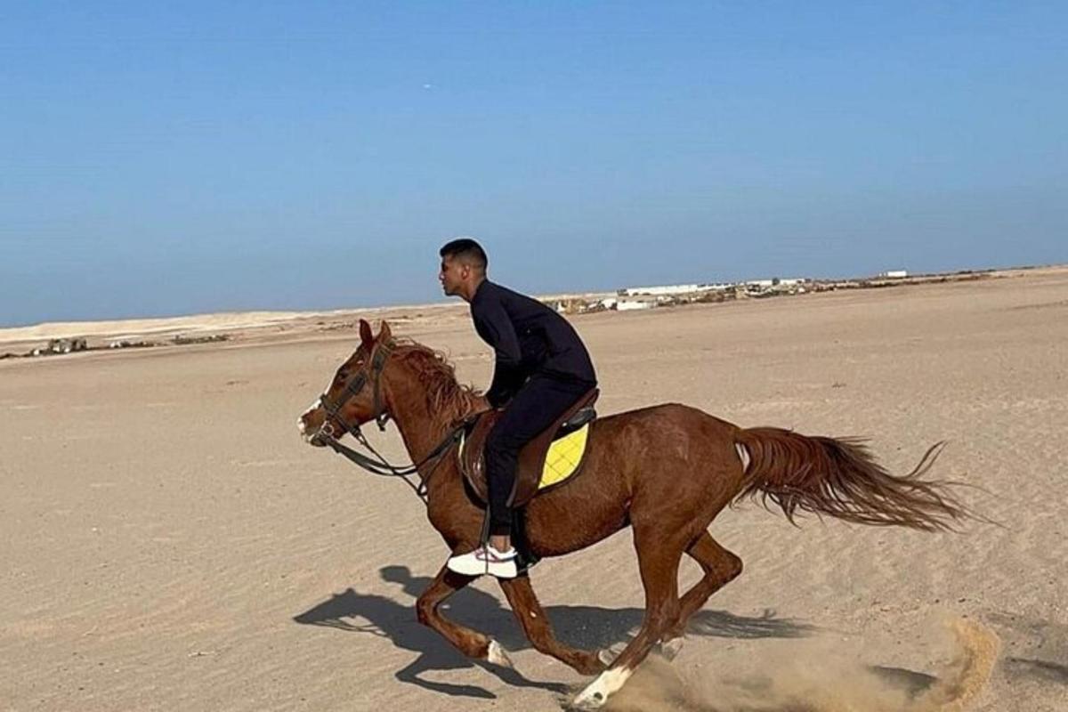 un uomo a cavallo sulla spiaggia