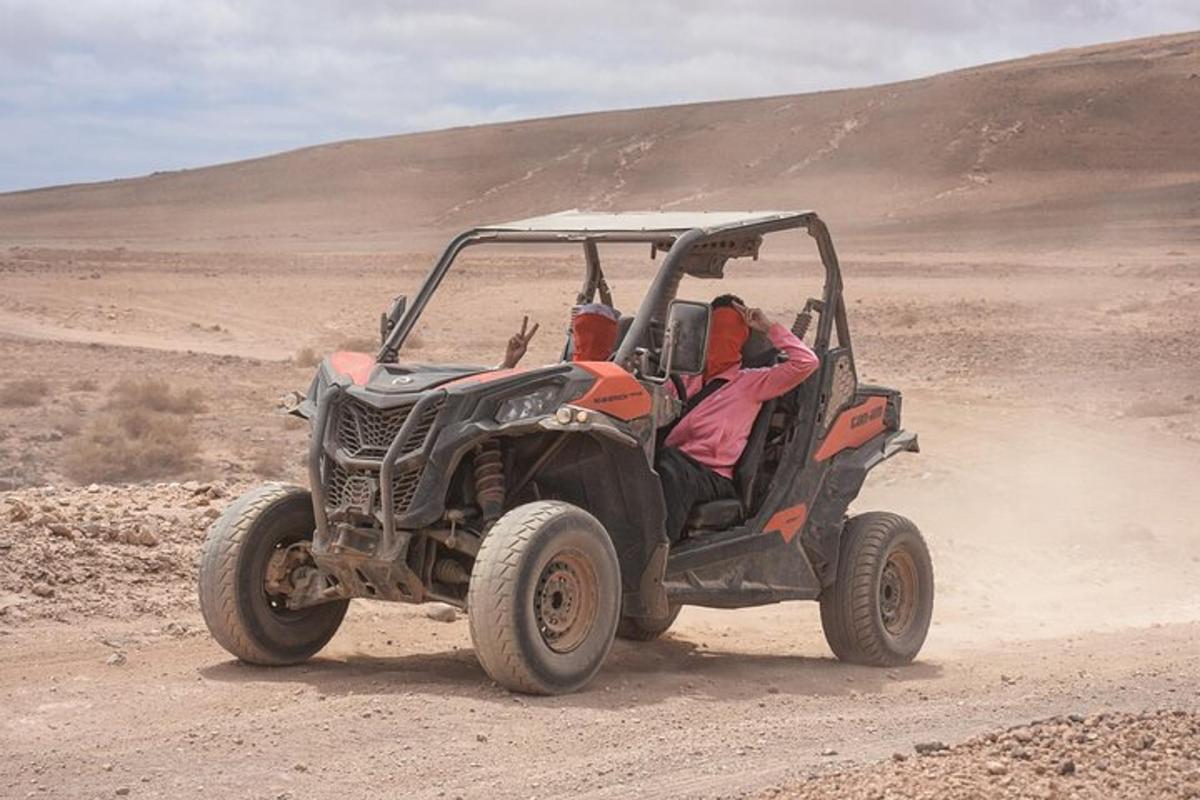 a person driving a jeep in the desert