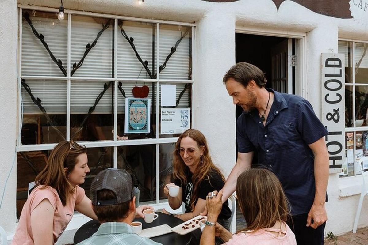 a man talking to a group of people at a table